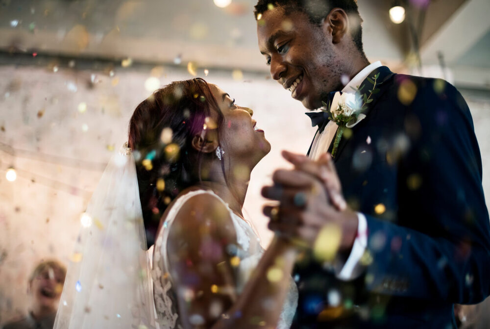 bride and groom smiling and dancing in candid wedding photo.jpg